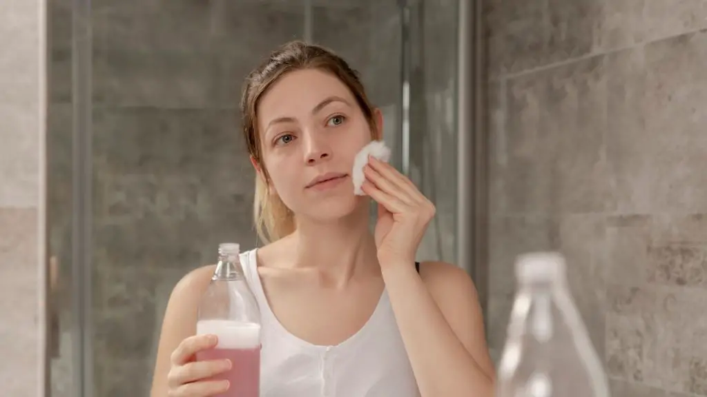 A woman cleansing her face skin