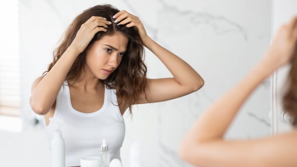 girl thinking about the risks of getting a Keratin Treatment While Pregnant
