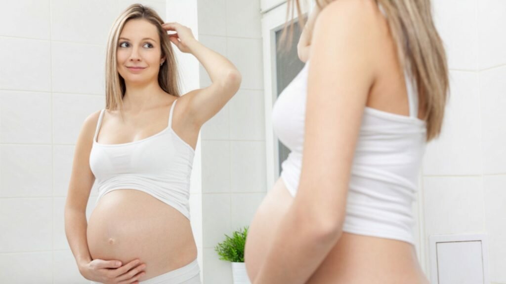 women touching her hair during her pregnancy