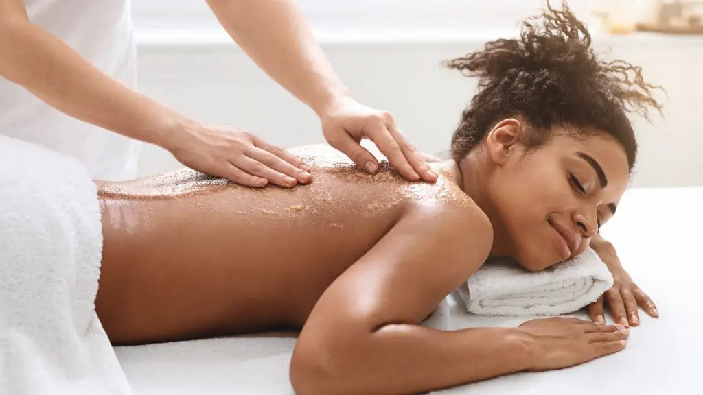 Black young woman getting exfoliating beauty procedure
