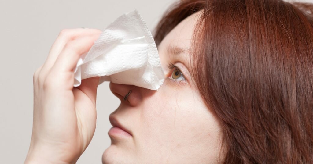 Woman cleaning her nose and nose ring