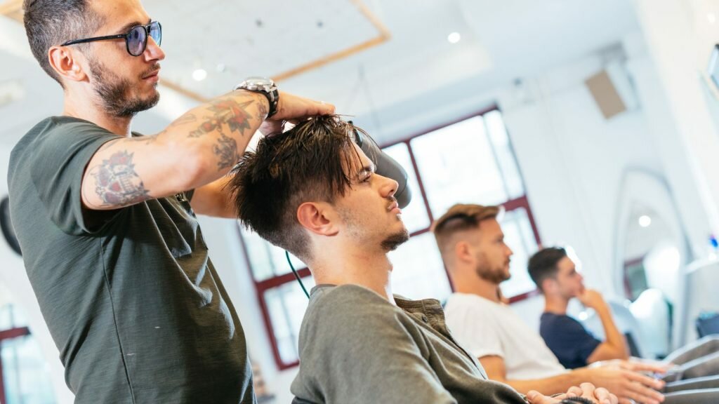 Teenage boy having hair cut