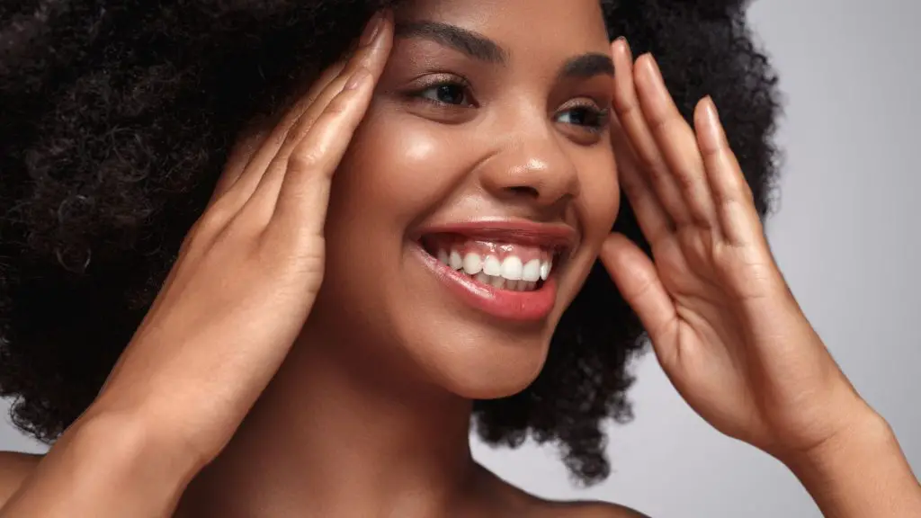 Smiling black woman with beautiful radiant skin
