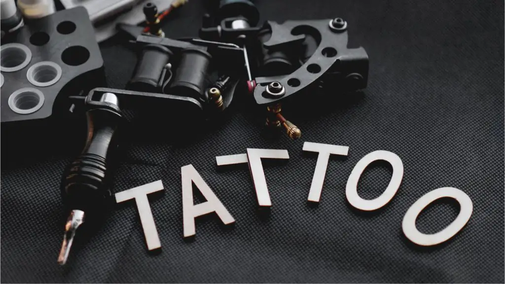Tattoo accessories with inscription tattoo of wooden letters