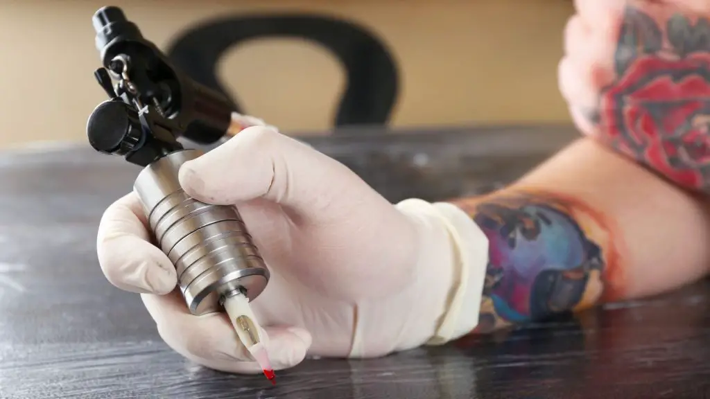 Tattoo artist holding Tattoo gun