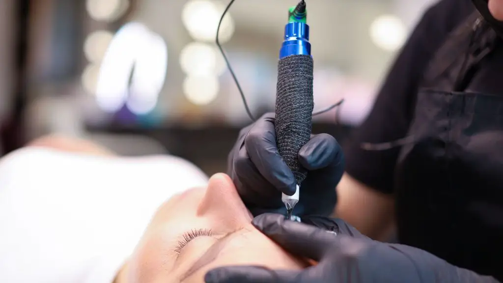 Tattoo artist making tattoo with tattoo pen