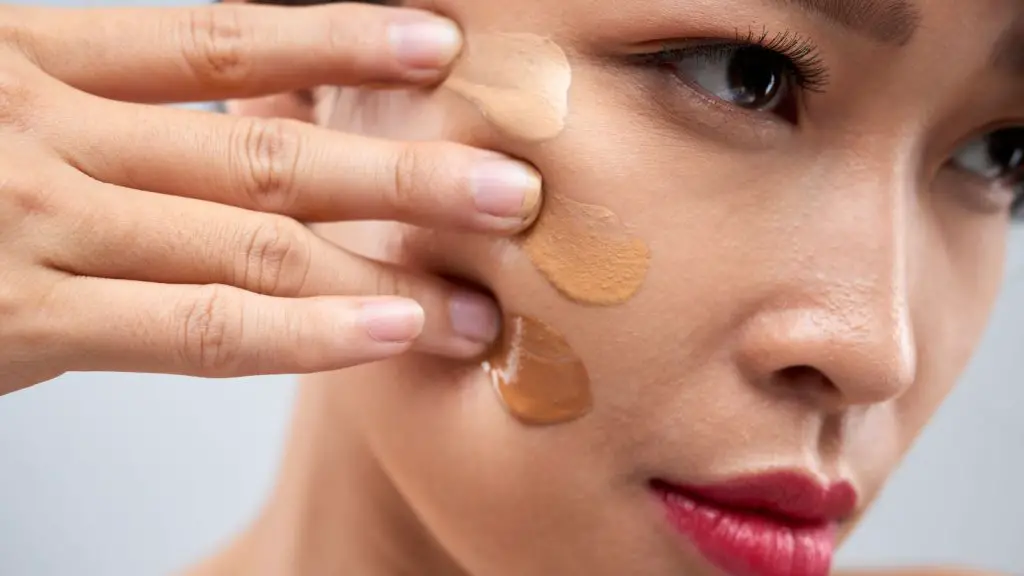 Woman applying too much foundation