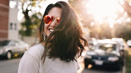 woman wearing white T-shirt smiling